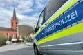Ein Kleinbus der Stadtpolizei auf dem Bahnhofsplatz in Limburg mit der evangelischen Kirche im Hintergrund.