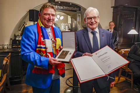 Günter Beck überreicht Gerd Ludwig die Gutenberg-Plakette der Stadt Mainz. 