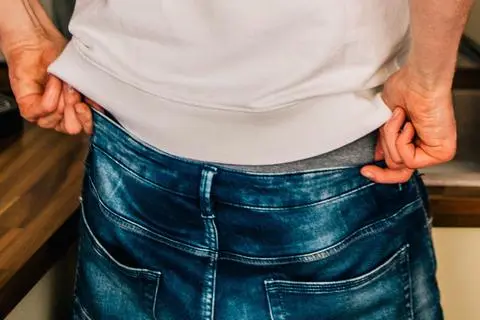 Mann zieht sich seine Hose hoch