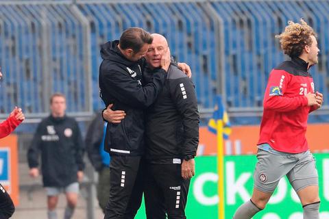 Geschafft: Während Benedict Hollerbach (rechts) und Lucas Becker nach dem Schlusspfiff auf das Spielfeld stürmen, gratulieren sich die SVWW-Interimstrainer Mike Krannich und Nils Döring (2. v. l.) erst einmal gegenseitig.  Foto: imago 